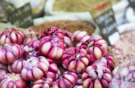 A selective focus of a pile of purple garlic displayed on a greengrocerの写真素材