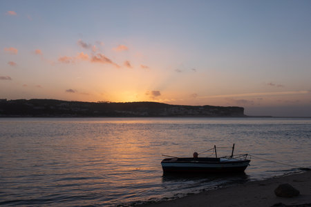 Fishing boats on a river sea at sunset in Foz do Arelho, Portugalの写真素材
