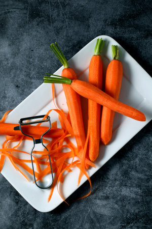 A high angle shot of freshly peeled carrots on a whiteの写真素材