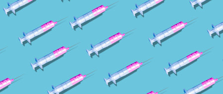 A creative pattern made with a syringe on blue background. New Coronavirus infection