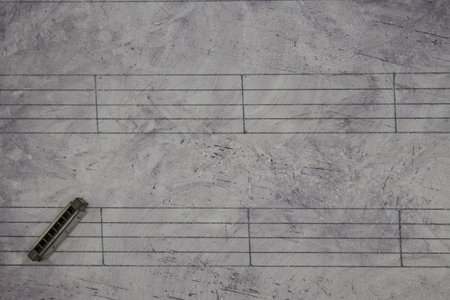 A music sheet background with a miniature instrument
