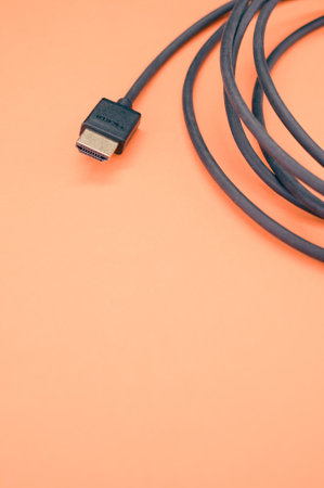 A closeup shot of HDMI cable isolated on a coral backgroundの写真素材