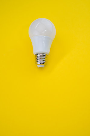 A closeup shot of a LED light bulb isolated on a yellow background
