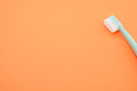 A closeup shot of a toothbrush isolated on an orange backgroundの写真素材