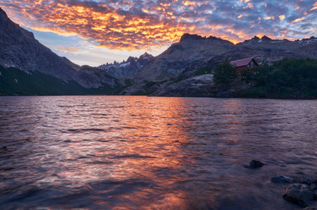 A mesmerizing view of the sea near mountains at sunsetの写真素材
