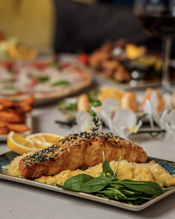 A closeup shot of a salmon fillet with mashed potatoes for garnish fresh herbalの写真素材