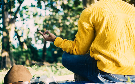 A man sitting in a forest and meditatingの写真素材