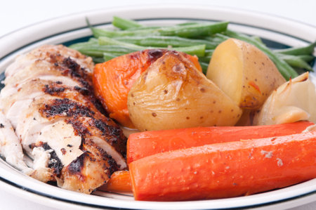 roast chicken dinner with sweet potato, carrots and beansの写真素材