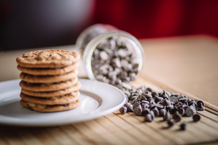 A plate of delicious chip cookies with chocolate candiesの写真素材