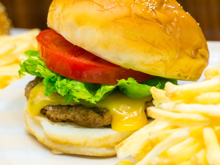 A closeup shot of a burger and on a white plateの写真素材