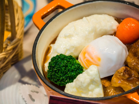 A closeup of vegetables with a poached egg cooked on a small potの写真素材