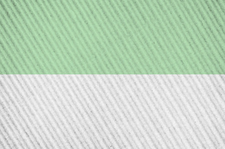 A closeup shot of a rough surface painted with white and green colors
