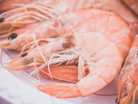 A closeup shot of a heap of grilled shrimps on a plateの写真素材