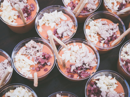 A closeup shot of a typical Spanish food served on plastic cupsの写真素材