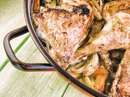 A closeup shot of a baked chicken in a potの写真素材