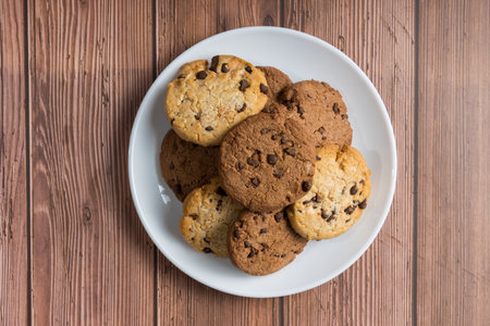 A top view of chocolate chip cookies on a wooden tableの写真素材