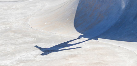 A closeup shot of a skateboarder's shadowの写真素材