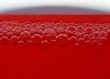 A macro shot of soap bubbles on red background