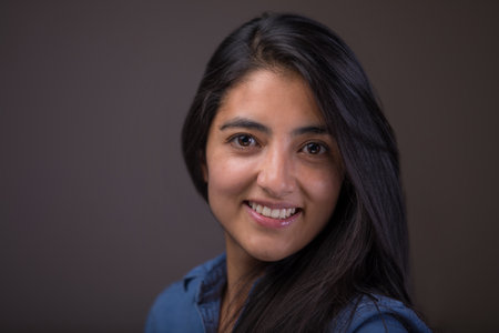 A Mexican young woman looking at the camera and smilingの写真素材
