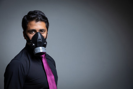 A closeup shot of a businessman in a protective gas maskの写真素材