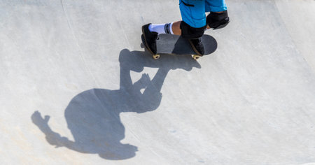 A closeup shot of a skateboarder's shadowの写真素材