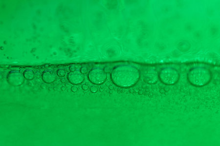 A macro shot of soap bubbles on green background