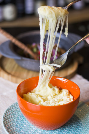A vertical shot of a Georgian traditional dish Tashmijabi with potatoes and cheeseの写真素材