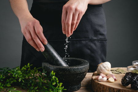 Woman hands cooking pouring salt into the mortar