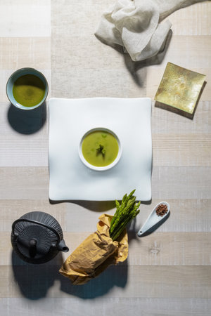 A vertical top view of a gourmet table with soup and vegetable dishesの写真素材