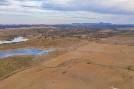Drone aerial panorama of a dam lake reservoir at sunset in Terena, Portugalの写真素材