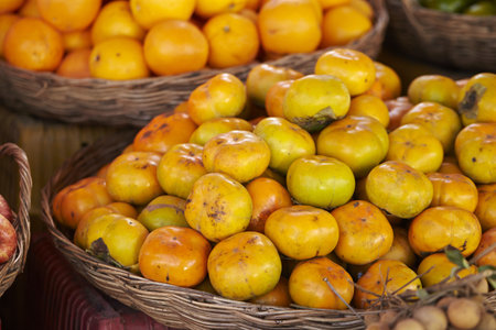 A selective focus shot of persimmons in a food market