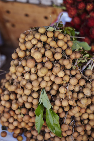 A vertical shot of longan in a food marketの写真素材