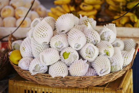 A selective focus  shot of fresh fruit with white foam nets in a marketの写真素材