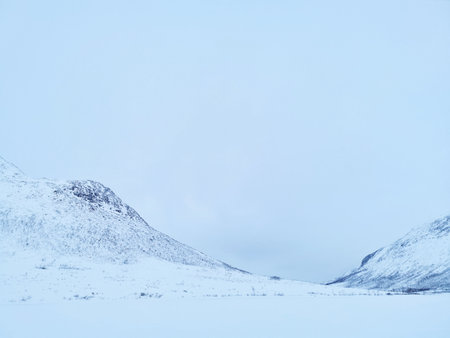 The beautiful view of snowy mountains in the Arctic, Kvaloya Island, Tromso, Norwayの写真素材