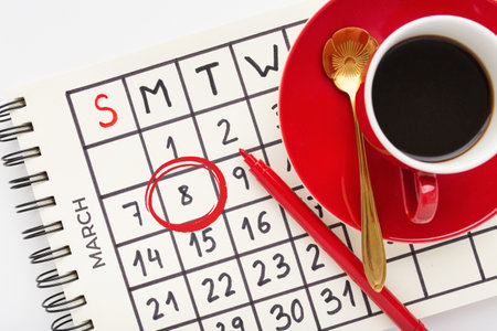 A closeup shot of a Women's day decoration set with a calendar marking the dayの写真素材