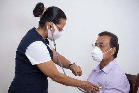 A Mexican nurse examining the patient with a stethoscope