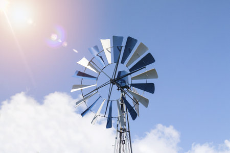 A low angle shot of a windmill on a sunny day