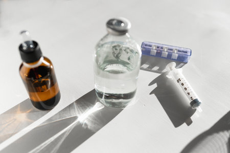 A closeup shot of syringe and medicals on a white backgroundの写真素材