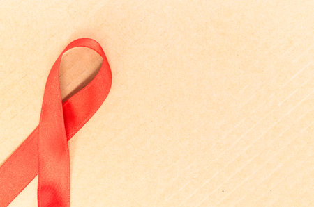 A top view of a red breast cancer awareness ribbonの写真素材