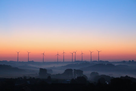 windmills for electricity generation at sunrise in Germany