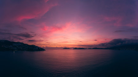 A scenic view of a calm sea with a beautiful sunset background