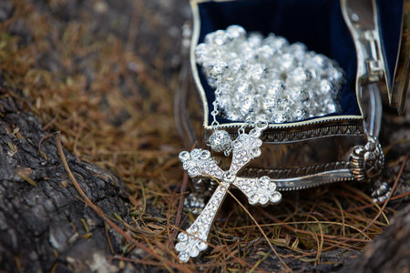 A high angle shot of a cross necklace in the metal boxの写真素材