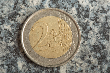 A high angle shot of a euro coin on a table