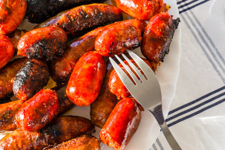 A closeup eating spicy sausagesの写真素材