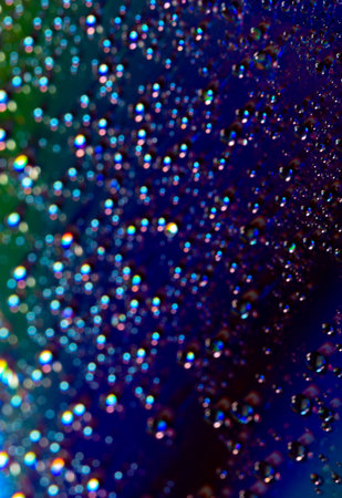 Blurry light effects with water drops on a blue background