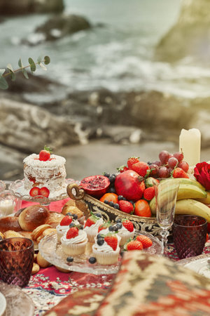 A vertical shot of a luxurious romantic picnic on a seashoreの写真素材