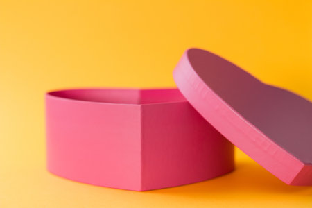 A Valentine's Day gift box in a heart shape isolated on a yellow background