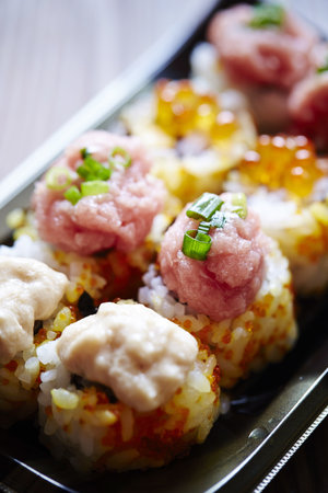 A vertical shot of delicious sushi rolls on a blurred backgroundの写真素材