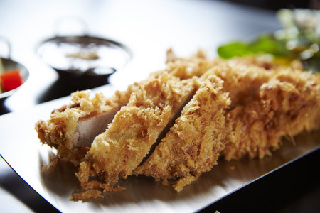 Fresh delicious pieces of crispy chicken on a blurred bakcgroundの写真素材