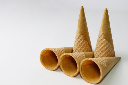 Empty ice cream cones stacked on each other on gray backgroundの写真素材